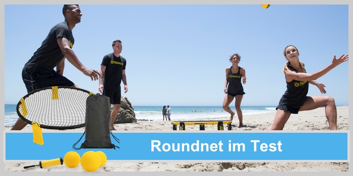 Roundnet im Test: 4 junge Menschen spielen Roundnet / Spikeball / Mini Volleyball am Strand